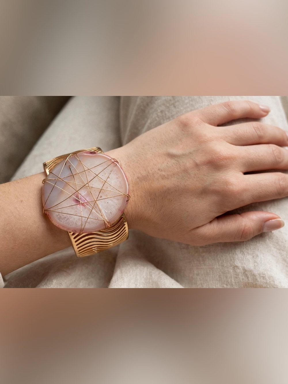 Pink stone wrapped in gold wiring bracelet